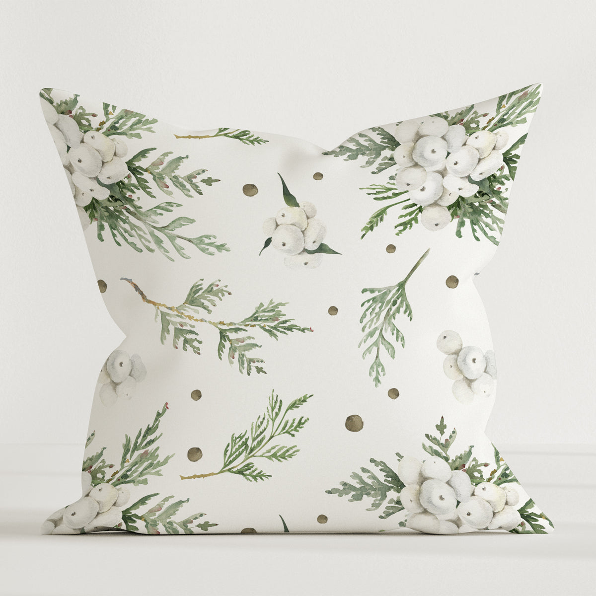Leslis-Dekokissen „Snowberry“ mit grünen Zweigmotiven auf hellem Grund.