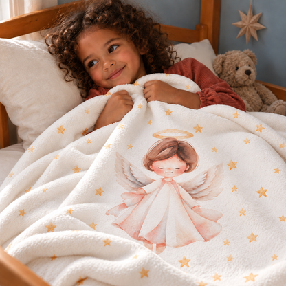 A child in bed under the “Christmas Angel” plush blanket.