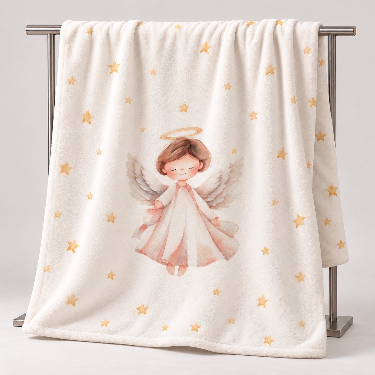 The “Christmas Angel” plush blanket hanging over a stand, showing the design.