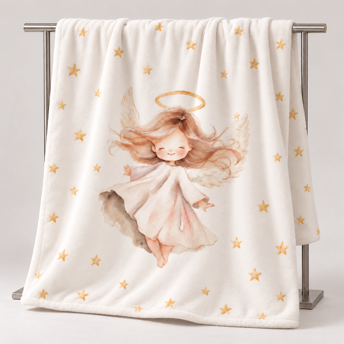 The “Angel” plush blanket hanging over a stand, showing the design.