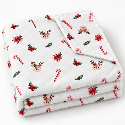 Gefaltete Kuscheldecke „Zuckerstangen und Rehe“ mit umgeschlagener Ecke auf weißem Hintergrund.